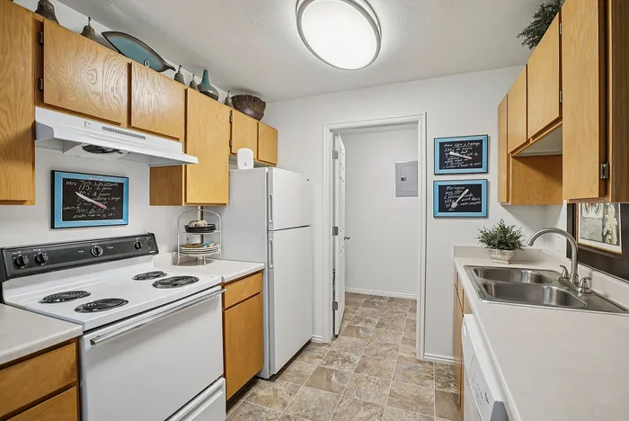 Charming kitchen with natural wood cabinets, modern appliances, and stylish decor accents, perfect for culinary enthusiasts.