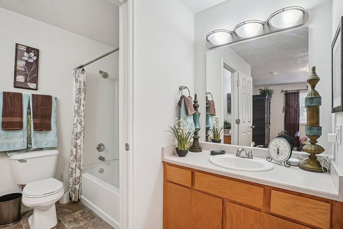 Charming bathroom with elegant decor, bright lighting, and a modern shower. Features stylish vanity and plush towels, offering a spa-like experience.
