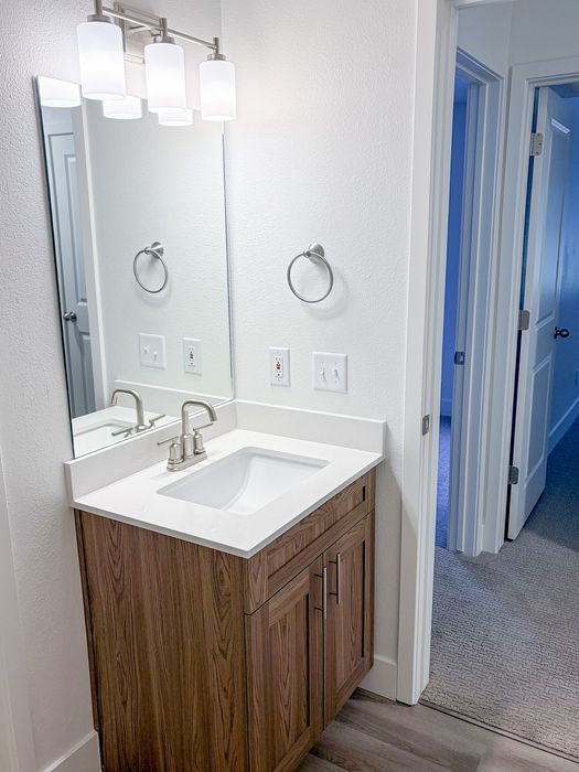 Modern bathroom finishes combine style and practicality with updated cabinetry and lighting.
