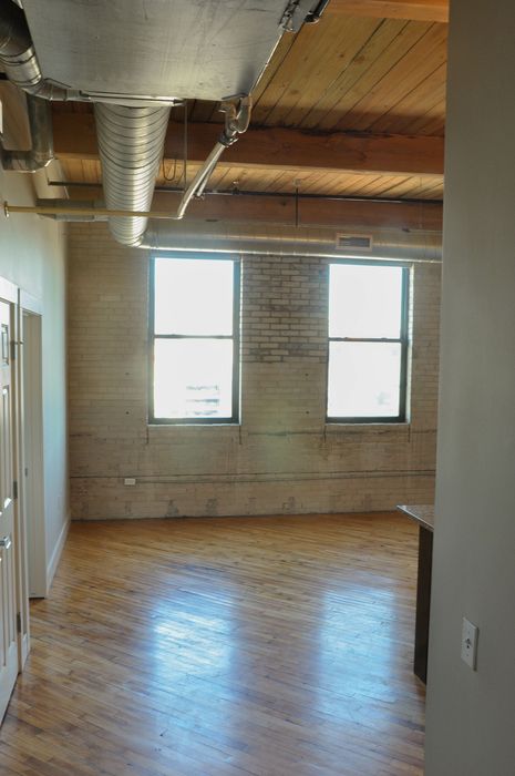 Chic urban loft with stunning exposed brick, gleaming hardwood floors, and industrial design details.