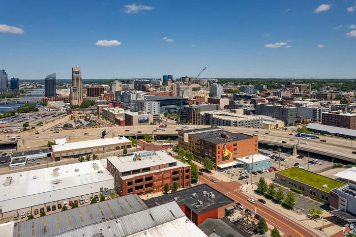 Vibrant downtown cityscape with modern architecture, scenic views, and a bustling atmosphere under a clear blue sky.