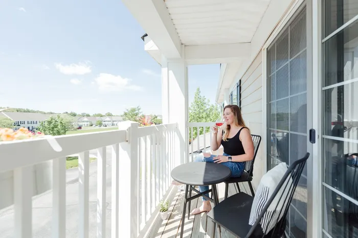 Resident Relaxing on the Balcony | Pflugerville TX Apartment Homes | LC Plfugerville | New Albany OH Apartment For Rent | LC New Albany
