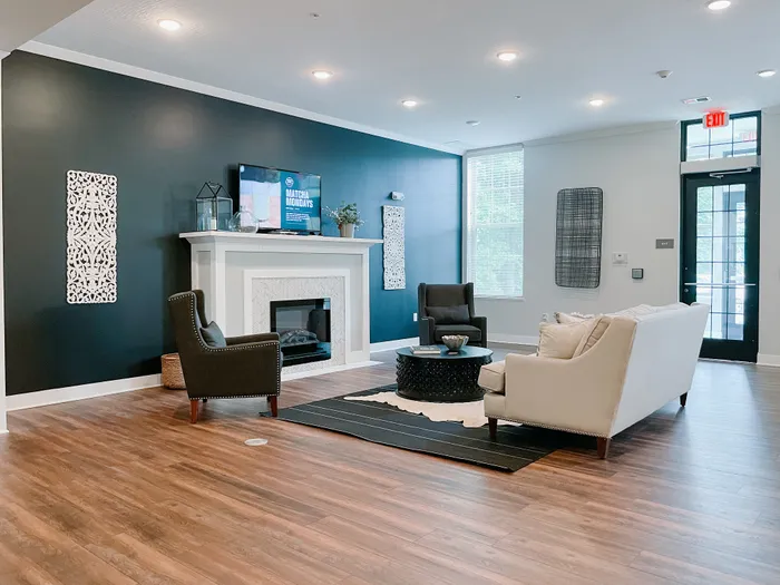 Elegant living space featuring a contemporary fireplace, cozy seating, and stylish decor elements.