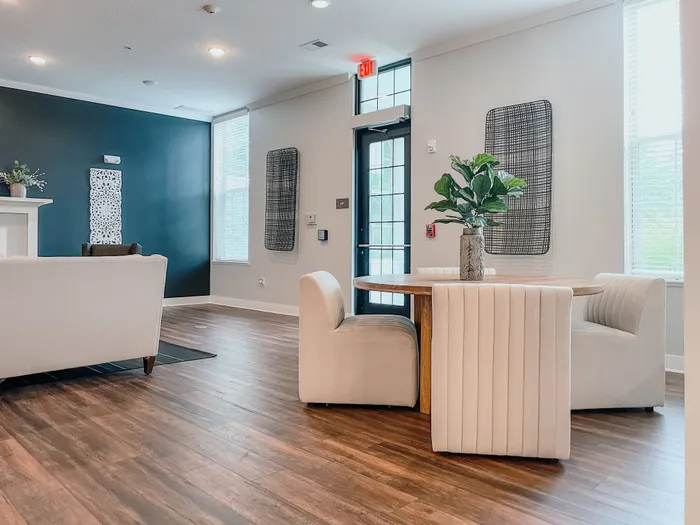 Inviting apartment lounge with modern furniture, wood flooring, and stylish wall decor.