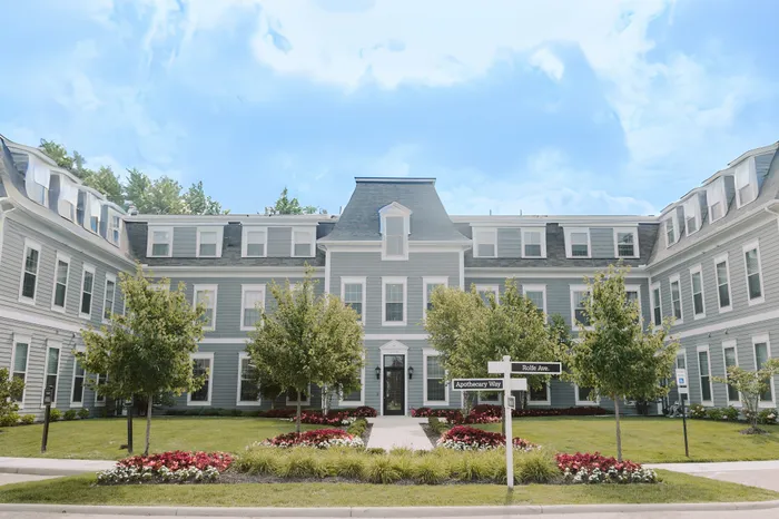 Charming large apartment building with manicured gardens and a classic architectural design.