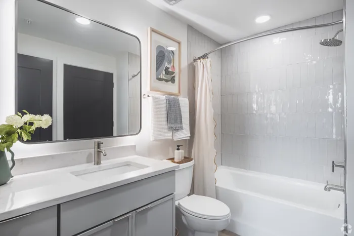 Elegant bathroom design with modern fixtures, luxurious white vanity, and stylish wall art.