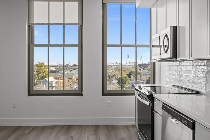 Bright and airy kitchen with modern appliances and stunning views through large windows overlooking a scenic landscape.