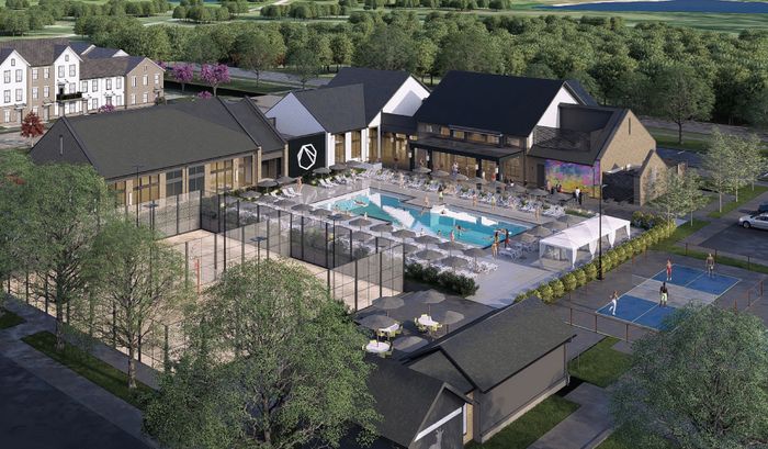 Luxurious apartment community aerial view showcasing a stunning pool area, modern clubhouse, and vibrant sports courts surrounded by lush greenery.