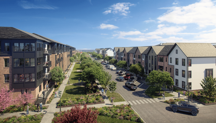 Charming residential street view showcasing modern apartments with lush landscaping, ample parking, and vibrant community life under a clear blue sky.