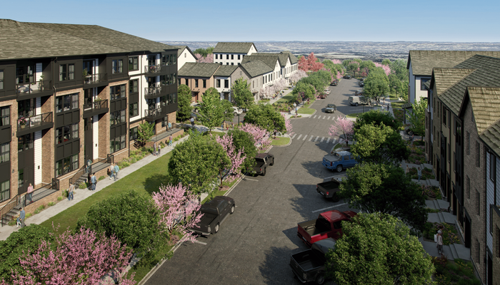 Charming residential street lined with modern townhouses and lush greenery, showcasing a vibrant community atmosphere.