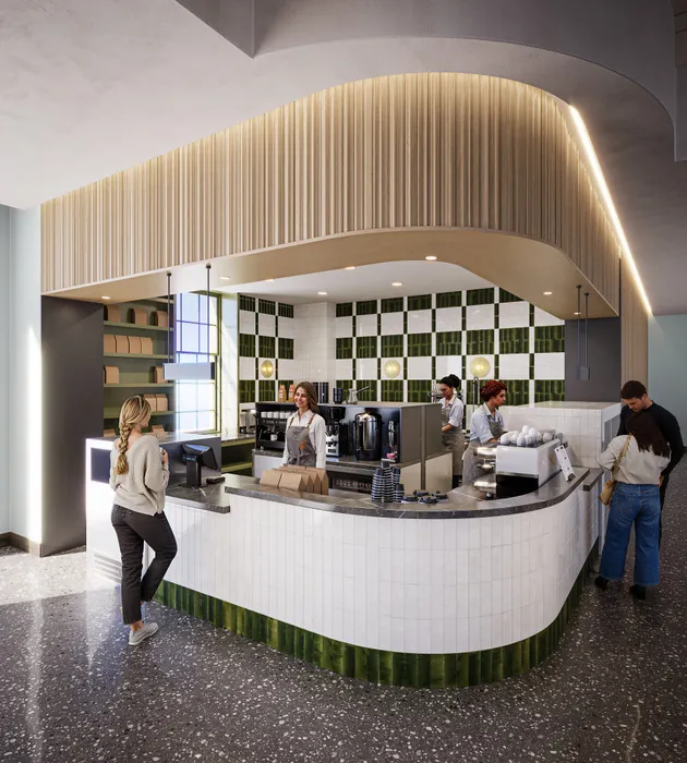 Modern coffee shop with stylish decor, featuring a curved counter, elegant lighting, and vibrant green accents providing a welcoming atmosphere.