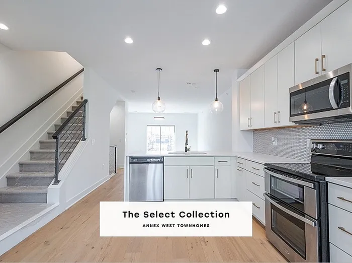 Bright and modern kitchen in The Select Collection at Annex West Townhomes featuring sleek cabinetry, stainless steel appliances, and elegant lighting.