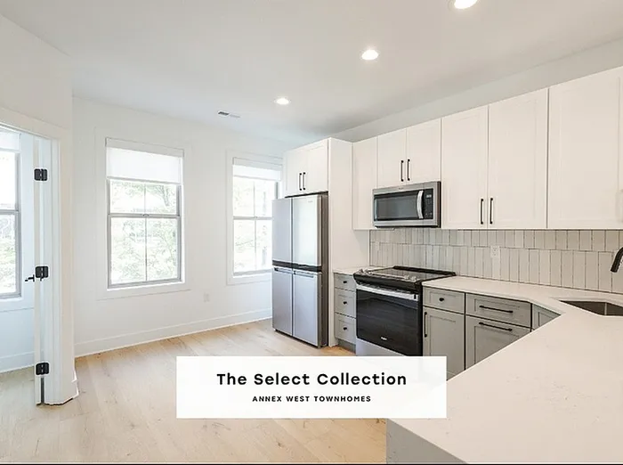 Bright and modern kitchen in The Select Collection at Annex West Townhomes, featuring sleek cabinetry and stainless steel appliances.