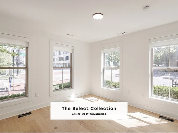 Bright and inviting room with natural light streaming through large windows, part of The Select Collection at Annex West Townhomes.
