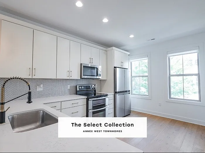 Bright modern kitchen in The Select Collection Annex West Townhomes featuring sleek cabinetry, stainless steel appliances, and elegant countertops.