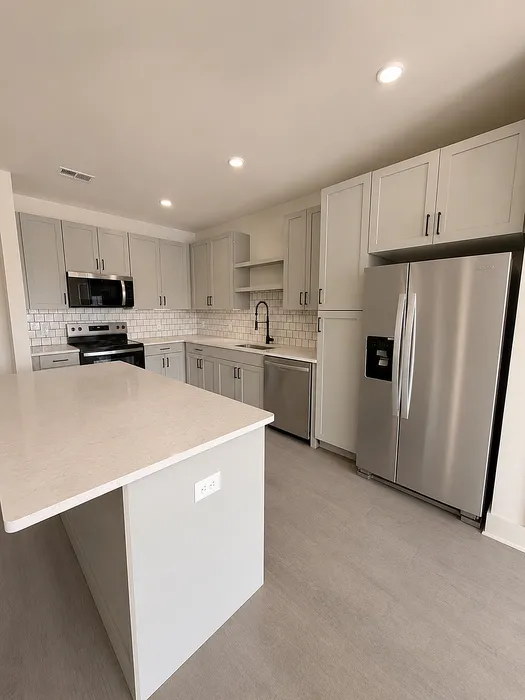 Modern kitchen with sleek cabinetry, stainless steel appliances, and a spacious island, perfect for cooking and entertaining.
