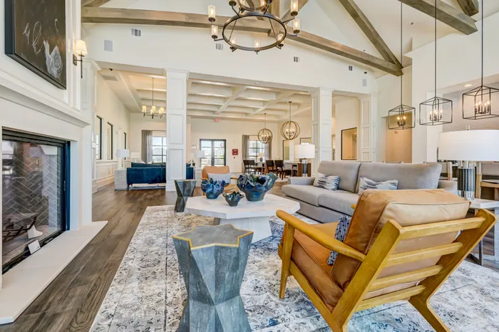 Resident clubhouse with coffee bar, seating area with TV's, and entertainment kitchen