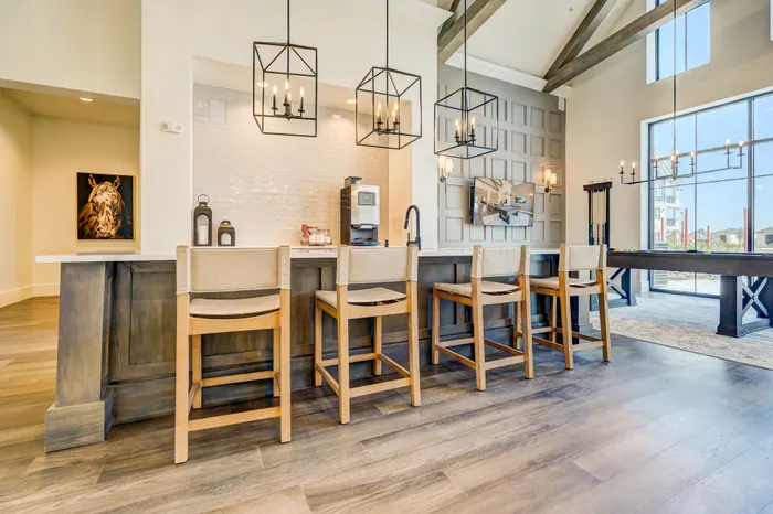 Resident clubhouse with coffee bar, seating area with TV's, and entertainment kitchen