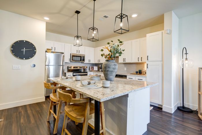 Spacious kitchens feature kitchen islands*, custom cabinetry, quartz countertops, and stainless steel appliances