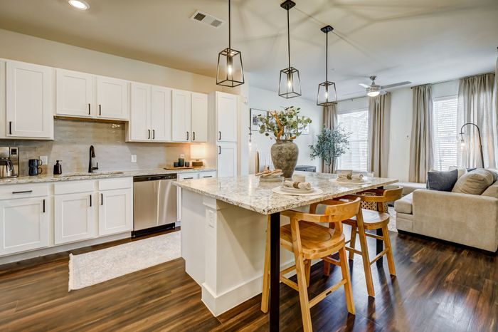 Spacious kitchens feature kitchen islands*, custom cabinetry, quartz countertops, and stainless steel appliances