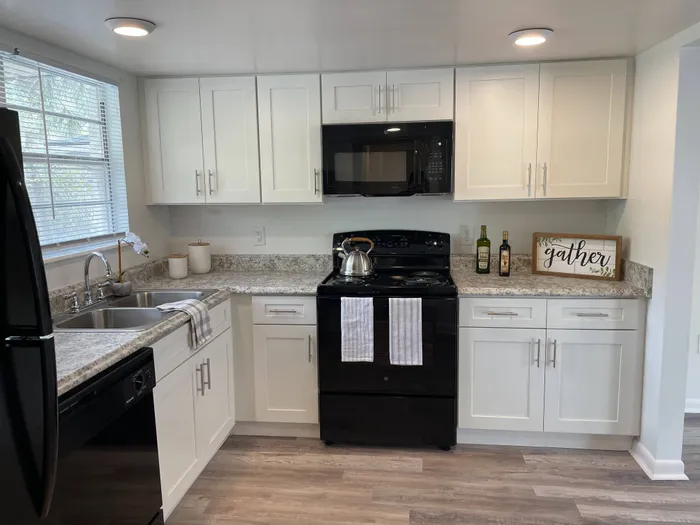 Updated Kitchen w/white cabinets and black appliances