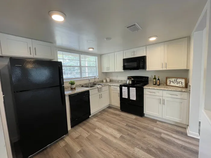 Updated Kitchen w/white cabinets and black appliances