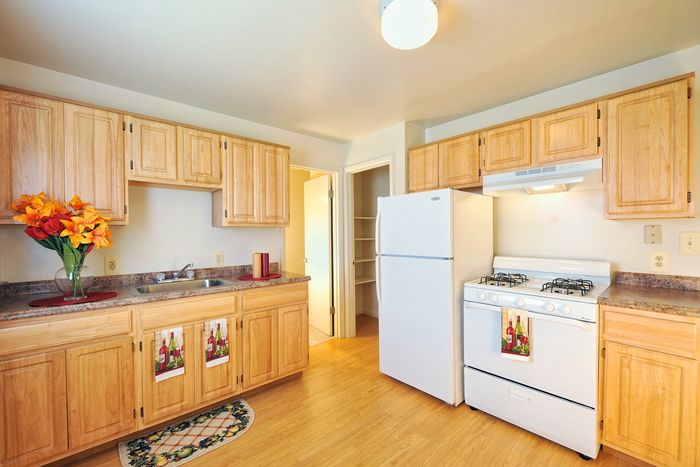 Kitchen with white appliances, gas range