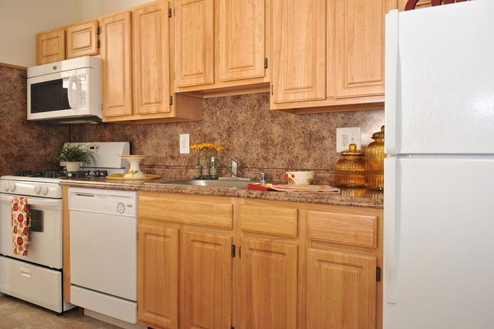 Kitchen with updated white appliances, gas range, dishwasher, frost free fridge