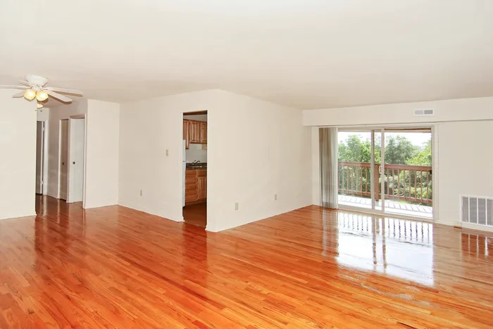 Living room, dining room with hardwood floors and balcony