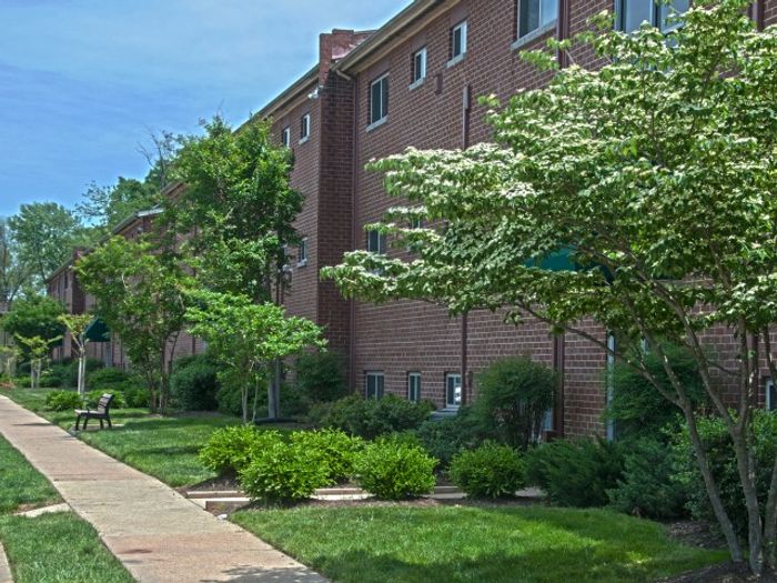 Crain Court Apts, Exterior, Landscaped exterior, 3 story buildings, controlled building entry, bench, walkway