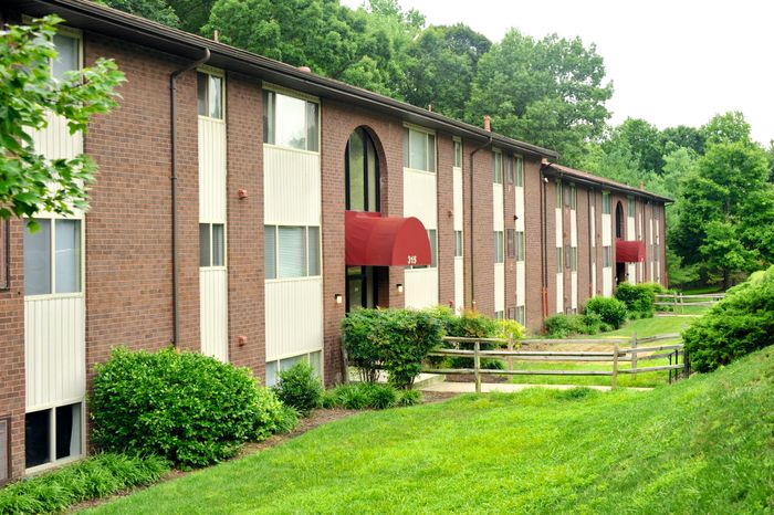 Cranberry Run Apts, Exterior, 3 story buildings, manicured grass, shrubs, and bushes
