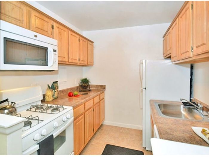 Galley Kitchen with updated white appliances, Gas range, dishwasher, and Frost free fridge