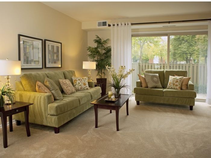 Living room with wall to wall carpet and walk out patio