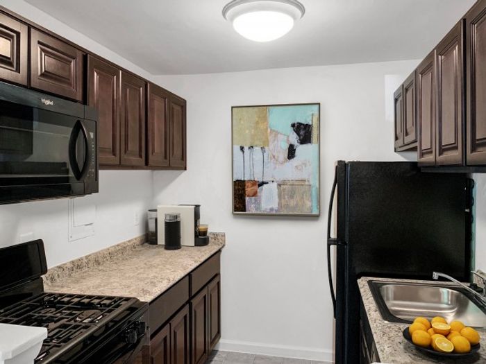 Galley Kitchen with updated black appliances, Gas range, dishwasher, and Frost free fridge