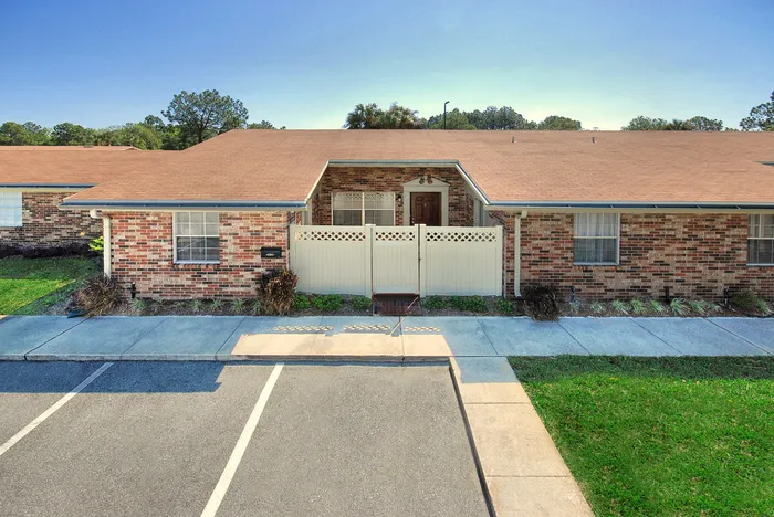 Beach Villas Apartments, exterior, parking, grass, walkways, single story brick building, privacy fences