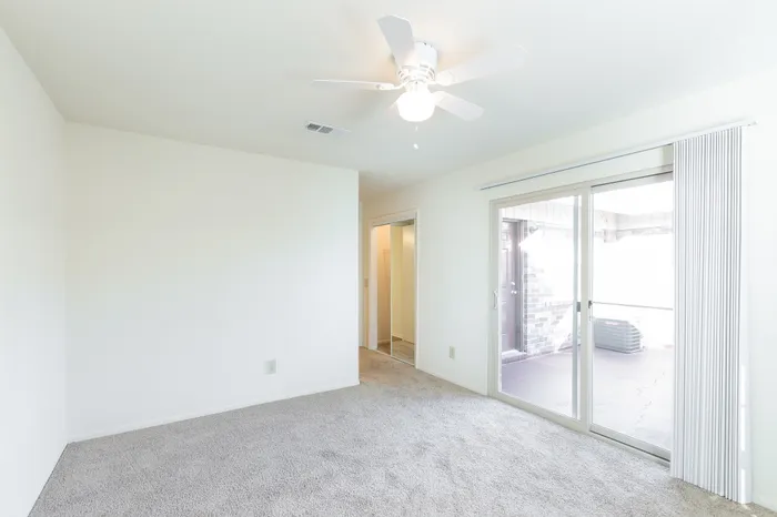 Beach Villas Apartments, interior, bedroom, carpet, sliding glass doors, ceiling fan