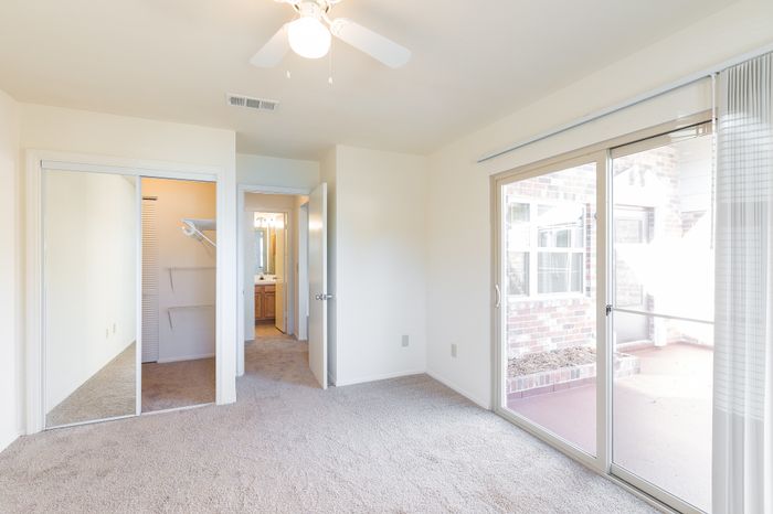Beach Villas Apartments, interior, bedroom, carpet, sliding glass doors, ceiling fan, closet