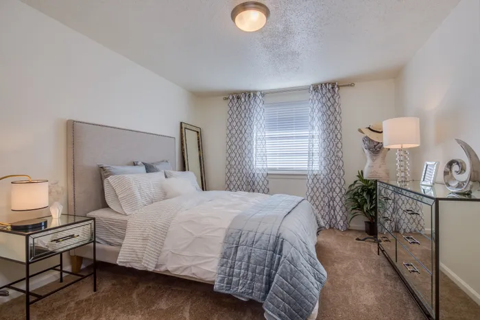 Canyon Square Apartments & Townhomes, interior, bedroom, carpet, blue and white bed, blue and white drapes, mirrored dresser and night stand,