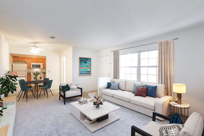 Beach Villas Apartments, interior, living room, dining room, kitchen, open flow, large window, white couch, carpet, wood floor, arm chairs, dining table, wood cabinets, white refrigerator, stove/oven, microwave
