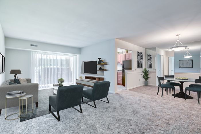 Fallstaff Manor Apts, interior, living room, dining room, plush wall to wall carpet, walkout patio, sofa, two chairs, 2 ottomans, large coffee table, TV console, round dining table, 4 chairs