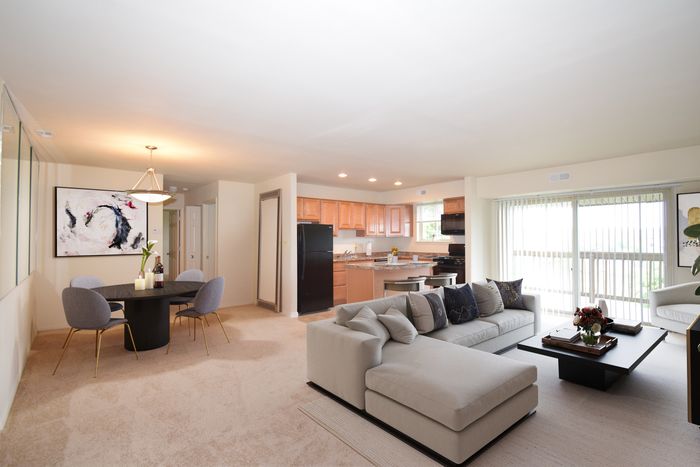 Fellowship Court Apts, Interior, Living room, sectional sofa, coffee table, chair, dining room, round table, 4 chairs, kitchen, kitchen island, black updated appliances, fridge, dishwasher, gas range, overhead microwave, patio, custom blind