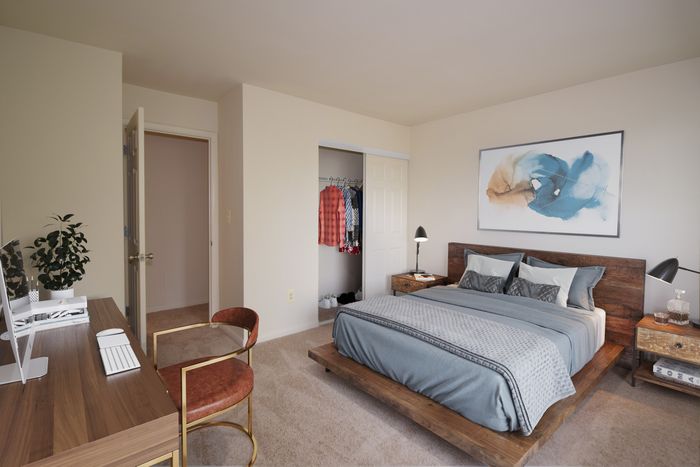 Bedroom with wall to wall carpet, closet along the wall