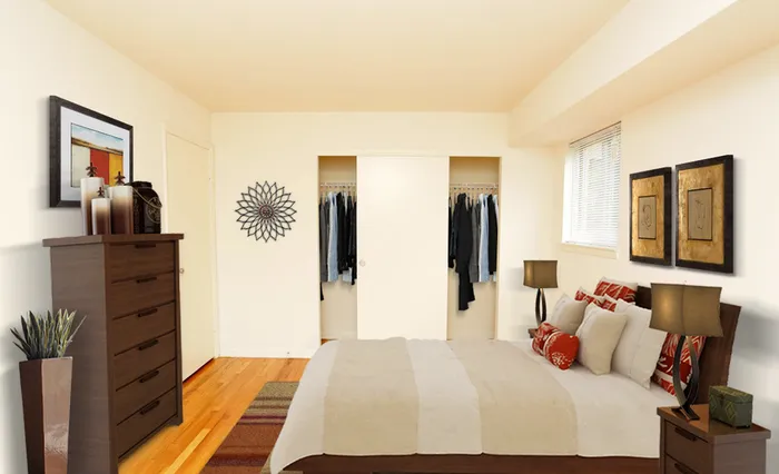 Bedroom with hardwood floors and closet along the wall