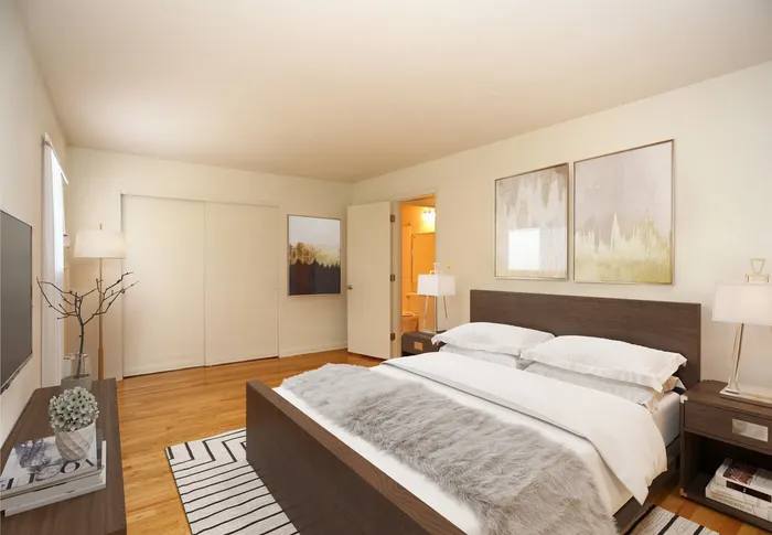 Master bedroom with hardwood floors and closet along the wall