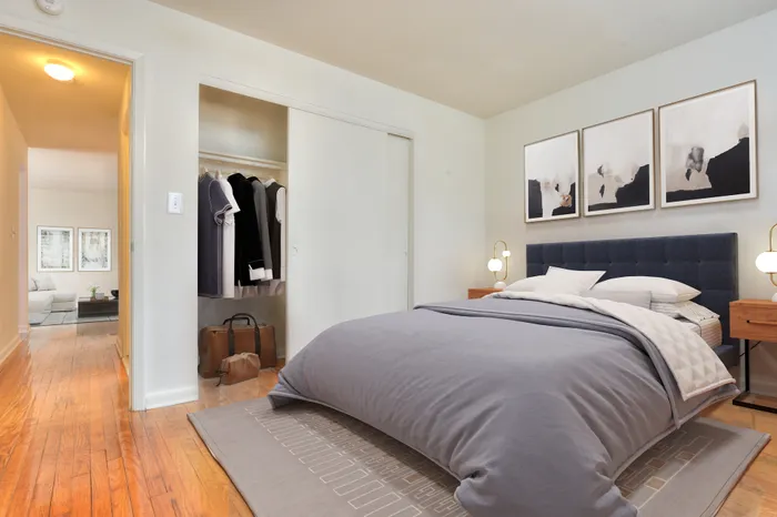 Bedroom with hardwood floors and closet along the wall