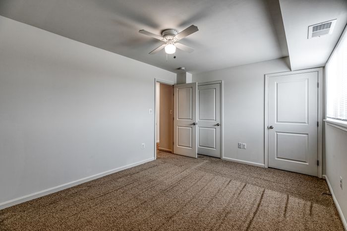 Bedroom with wall to wall carpet, closet along the wall