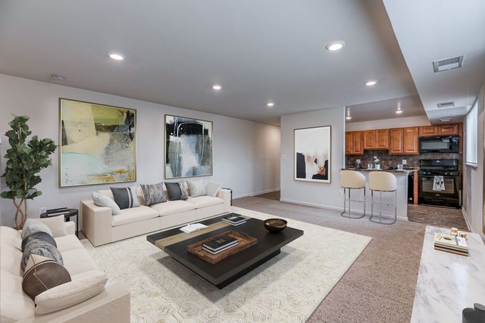 Living room, breakfast bar, and kitchen with updated black appliances