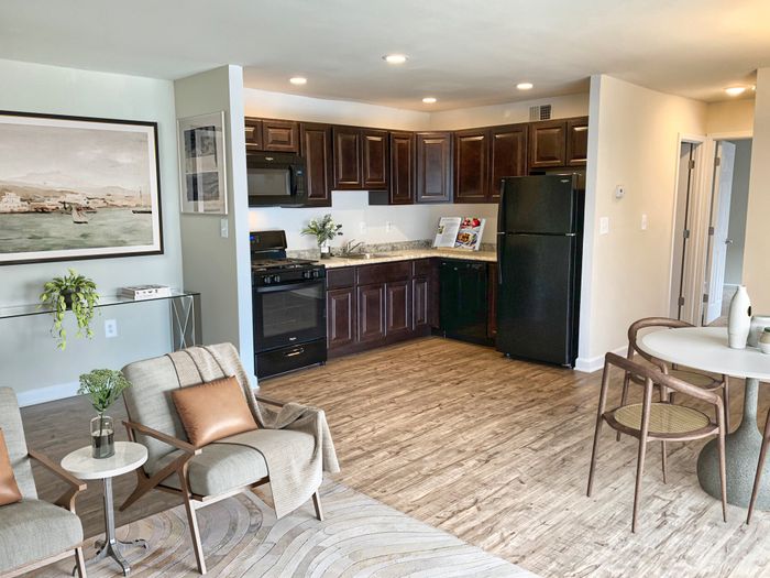 Open kitchen, wood flooring, dark cabinets