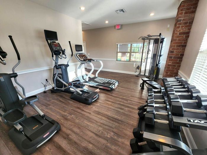 Fitness Center. Exercise machines. Free weights. Natural light. Hardwood floors.