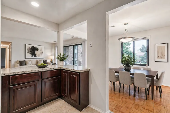 kitchen breakfast bar with plenty of cabinetry, dining room
